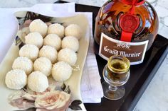 a bottle of wine and some food on a tray next to a plate with donuts