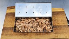 a box filled with wood chips on top of a wooden table