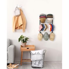 a wall mounted shelf with hats and shoes on it