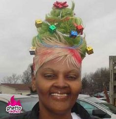 a woman with pink hair wearing a green christmas tree on top of it's head