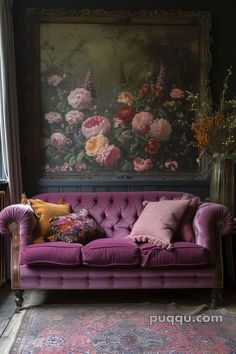 a purple couch sitting in front of a painting