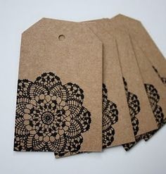 six brown tags with black lace doily on the front and back of each tag