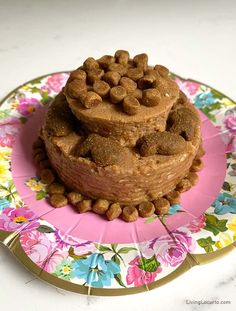 two pieces of cake sitting on top of a pink and yellow plate with flowers around it