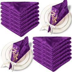 a stack of purple napkins sitting on top of each other next to a white plate