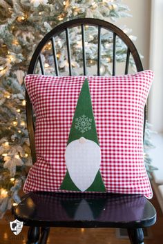 a christmas pillow sitting on top of a chair