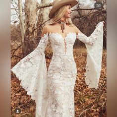 a woman in a white dress and cowboy hat