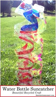 a sculpture made out of plastic bottles in the grass