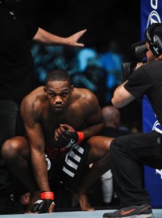 a man kneeling down in front of a referee