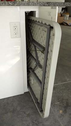 an open refrigerator door in the middle of a kitchen