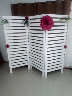 a room divider decorated with flowers and greenery