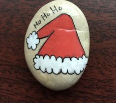 a rock with a santa hat painted on it