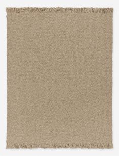 a beige rug with fringes on it