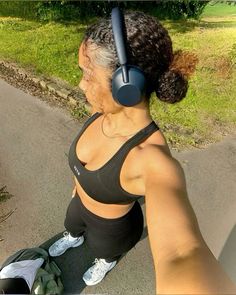 a woman with headphones on sitting in the street