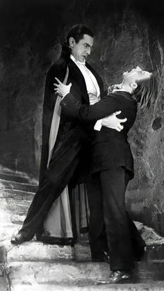 an old black and white photo of a man in a suit dancing with a woman