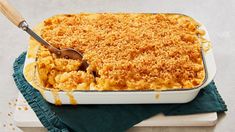 a casserole dish with macaroni and cheese in it on a blue towel