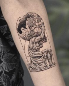 a woman's arm with a tattoo on it that has an image of a man holding