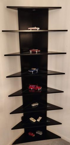 a tall black shelf with toy cars on it