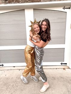 two girls are hugging each other in front of a garage door