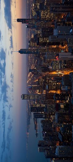 an aerial view of new york city at night from the empire building, looking down on the skyline