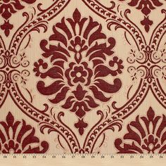 a red and white wallpaper with an ornate design on it's side, next to a ruler