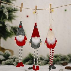 three christmas decorations hanging from a clothes line