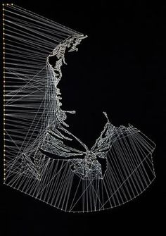 a wire sculpture is shown against a black background