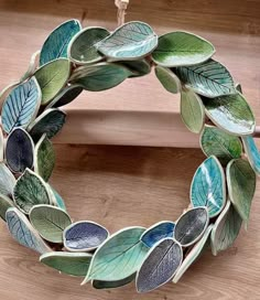 a wreath made out of leaves hanging on a door