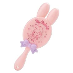 a pink hair brush with a purple bow on it's head and an image of a bunny