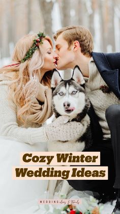 a couple kissing their husky dog in the snow