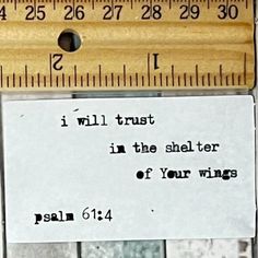 a piece of paper taped to a ruler that says i will trust in the shelter of your wings