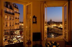 an open window overlooking a city at night