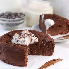 two slices of chocolate cake with whipped cream on top and one slice missing from it