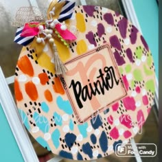 a colorful door hanger with the word paxton on it