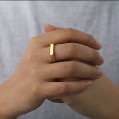 a woman's hand with a gold ring on it