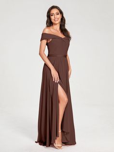 a woman in a long brown dress posing for the camera