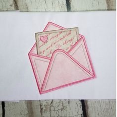 an envelope with a pink heart on it