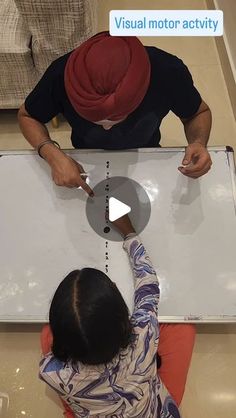 two people sitting at a table working on a project with the words visual motor activity