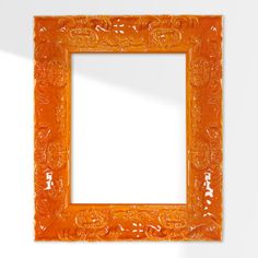 an orange frame on the wall with a white background