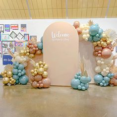 balloons are arranged in the shape of letters and flowers on display at an art show