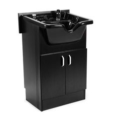 a black sink sitting on top of a wooden cabinet next to a faucet