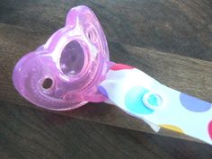 a baby pacifier sitting on top of a wooden table