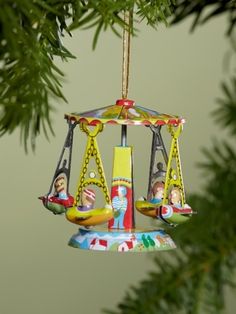 a merry go round ornament hanging from a tree