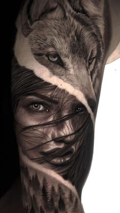 a man's arm with an image of a wolf and trees on the side