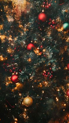 a christmas tree with red, green and gold ornaments