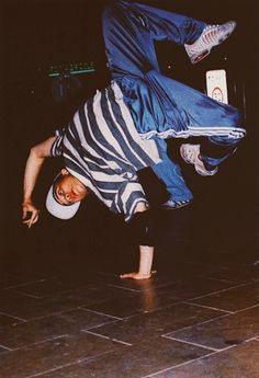 a man doing a handstand on the floor with his feet in the air