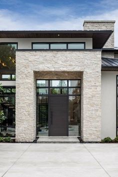 the front entrance to a modern home with large windows