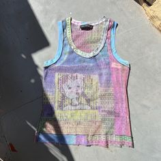 Vintage Y2K mesh vest top by French brand Cop Copine 💕 Pastel multi colours and graphic print on front and reverse including some text.  UNISEX SIZE: small - FR 34/36 or small 38 CONDITION: excellent - no flaws #copcopine #mesh #y2k #2000s #00s #graphic #top #trend #french #marque #topenmesh #y2kcopcopine Multicolor Mesh Top For Summer, Y2k Sleeveless Vest For Streetwear, Multicolor Graphic Print Tank Top For Spring, Y2k Graphic Print Vest For Spring, Trendy Fitted Vest With Graphic Print, Trendy Multicolor Cotton Vest, Casual Mesh Vest For Summer, 90s Style Graffiti Print Tops For Spring, 90s Style Vest Top For Spring