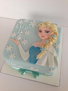 a frozen princess birthday cake with frosting on the top and numbers on the bottom