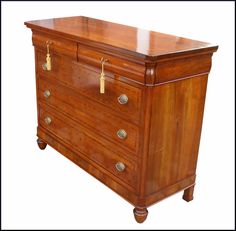 an antique chest of drawers with brass handles