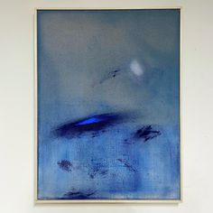 a blue painting hanging on the wall